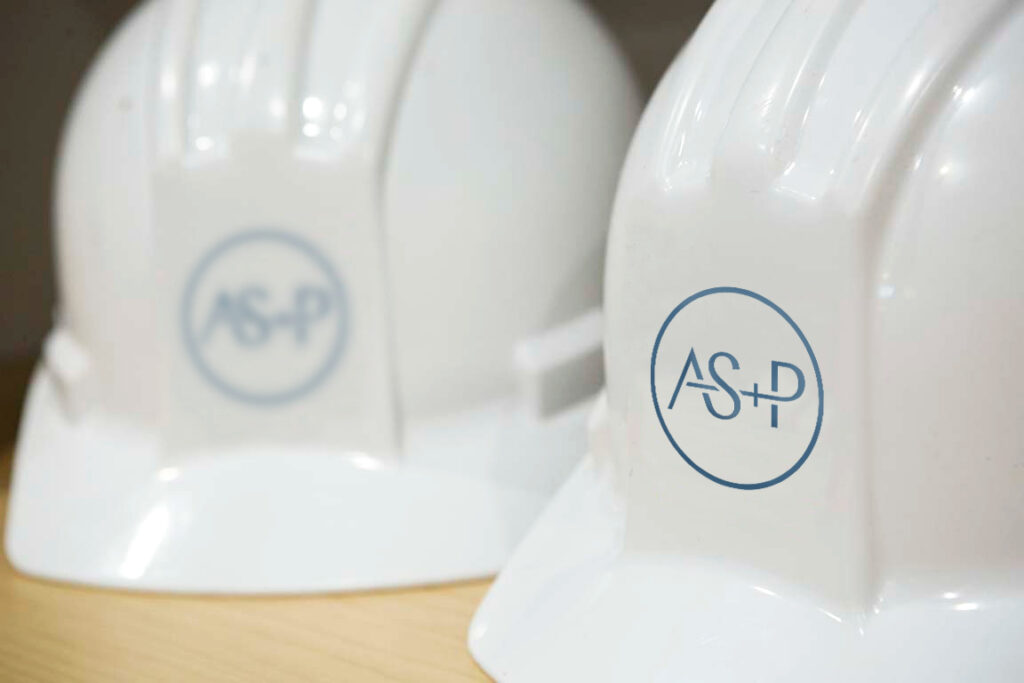 Hard hats with the AS+P logo.