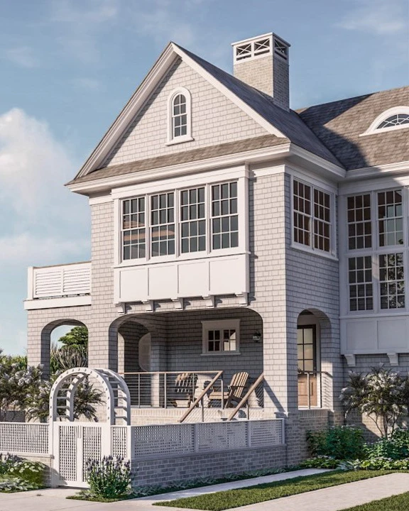 Contemporary coastal residence with shingle facade, gabled roof, multi-pane windows, and covered porch entry.