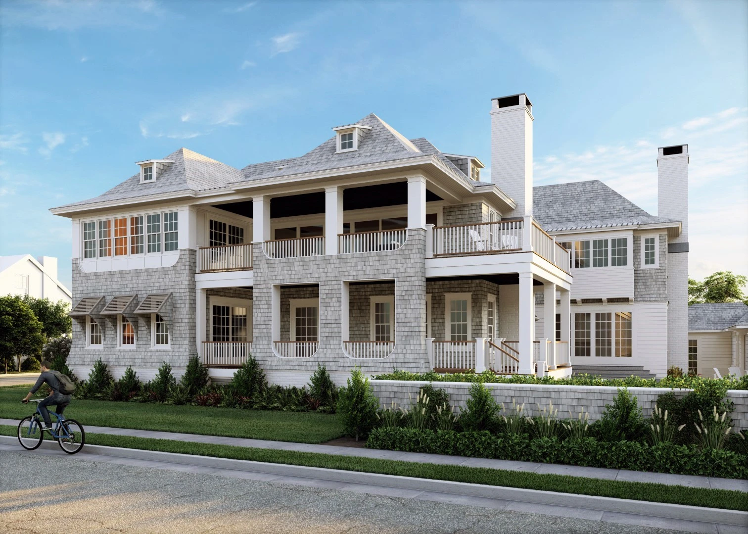 Modern coastal home with shingle and stone facade, multi-level design, covered porches, and tall chimneys.